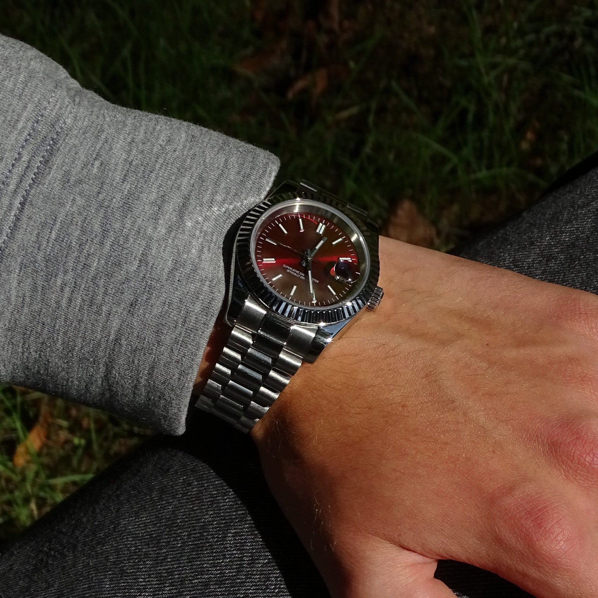 Elusivy watch on wrist with chrome red dial