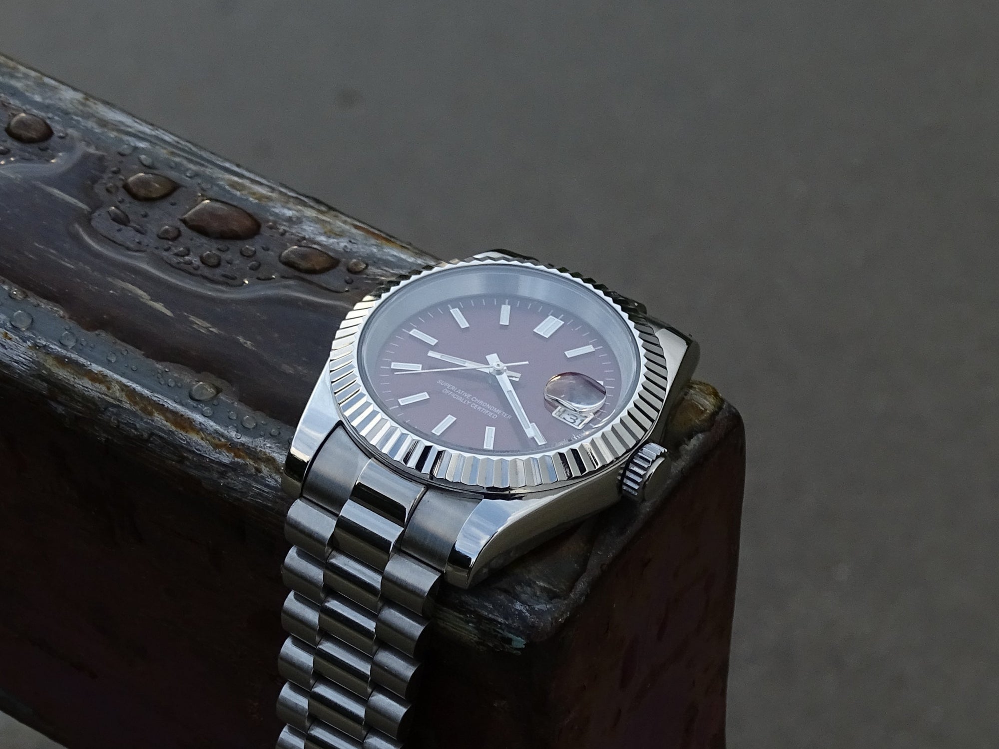 Elusivy luxury watch on pole with chrome red dial